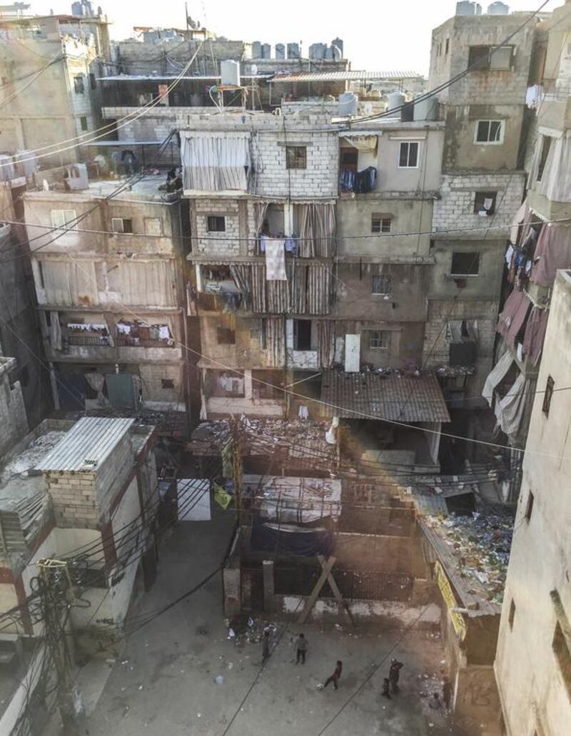 In Shatila, tens of thousands of people are confined to an area less than 1 square kilometre in size. One of the only open spaces in the camp is a dirt yard outside the CYC. At the bottom of the photo it is just possible to make out children playing football in the yard with a rusty metal wood burner. December 8, 2015. Courtesy Tomas Jivanda