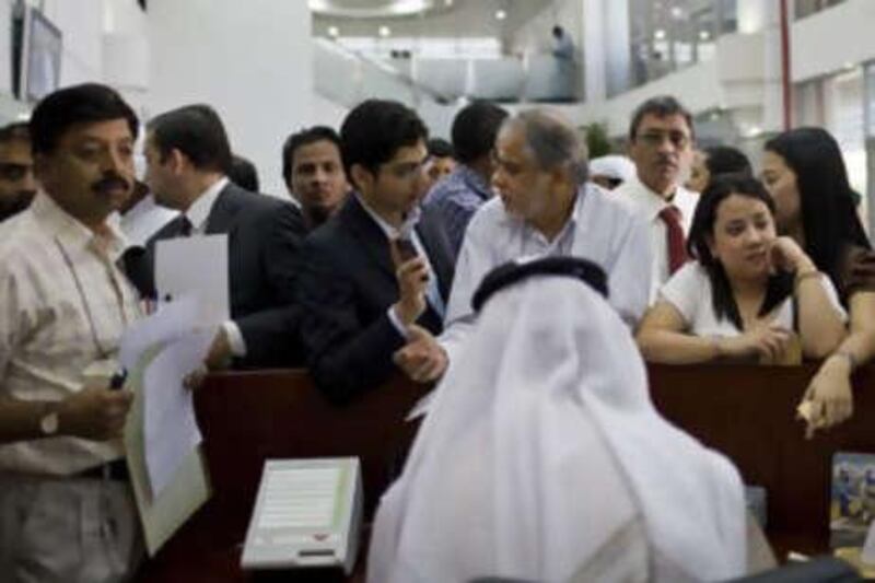 People attempt to apply for the new ID card at an Emirates Identity Authority Office in Dubai.