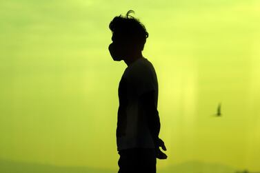 A Filipino villager in a facemask along the Manila bay on the eve of World Earth day, Philippines, 21 April. According to reports, the rehabilitation of the murky waters of Manila Bay is put on hold as the Philippine government is engulfed in the public health response to the spread of the coronavirus crisis. Francis R. Malasig/ EPA 