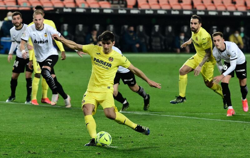 Villarreal's Spanish forward Gerard Moreno shoots a penalty kick and scores a goal during the Spanish League football match between Valencia and Villarreal at the Mestalla stadium in Valencia on March 5, 2021. / AFP / JOSE JORDAN
