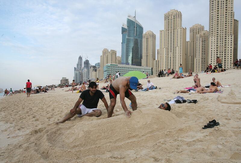 Dubai, United Arab Emirates, Eid Holiday , News desk - JBR Beach-  (Burried in the Sand) Riyaz Mahoo of India get covered in sand by friends along the shoreline at the JBR Beach. Beaches and Parks around Dubai started filling up early, thousand s will enjoy the extended break due to the Eid Holiday. Mike Young / The National