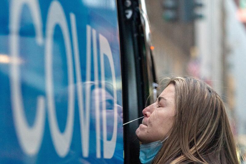 A woman takes a Covid-19 test at a pop-up testing site as the Omicron coronavirus variant continues to spread in Manhattan, New York. Reuters