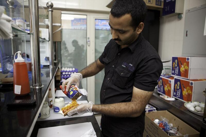 Its precise origins are a mystery, but most believe the sandwich is a schoolboy creation from the 1980s or 1990s derived from the much-loved Chips Oman milkshake, laban stirred with crushed chips and a few drops of hot sauce. Jaime Puebla / The National