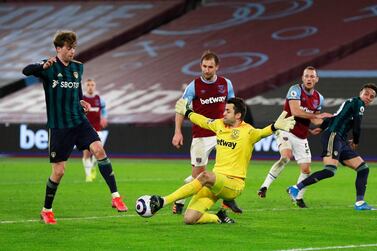 Soccer Football - Premier League - West Ham United v Leeds United - London Stadium, London, Britain - March 8, 2021 Leeds United's Patrick Bamford in action with West Ham United's Lukasz Fabianski Pool via REUTERS/Ian Walton EDITORIAL USE ONLY. No use with unauthorized audio, video, data, fixture lists, club/league logos or 'live' services. Online in-match use limited to 75 images, no video emulation. No use in betting, games or single club /league/player publications. Please contact your account representative for further details.