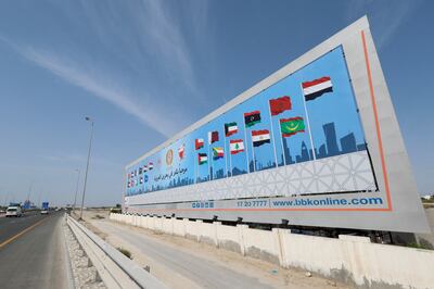 A billboard shows the flags of countries participating in the Arab League Summit that will take place in Manama. Reuters