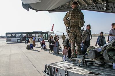 British and dual  citizens board a military plane at the airport in Kabul in August. EPA