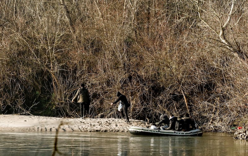 Migrants on a dinghy cross the Evros river and reach Greece, pictured from the Turkish border city of Edirne, Turkey. Reuters