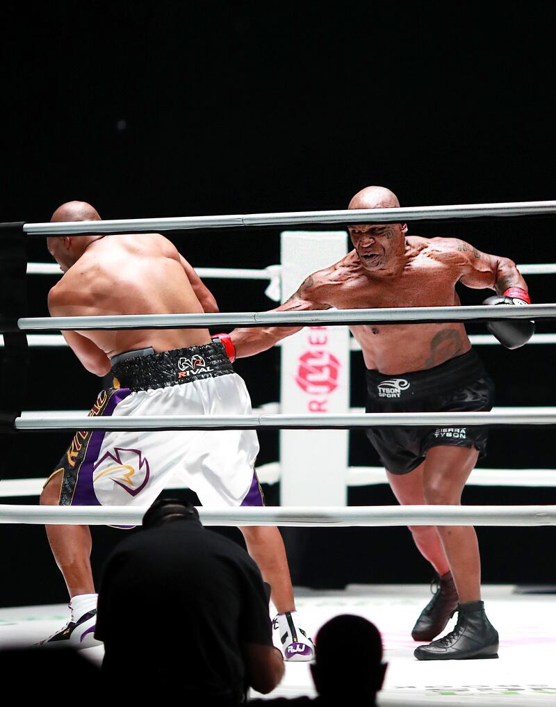 Mike Tyson (R) throws a punch in the fourth round against Roy Jones Jr. AFP