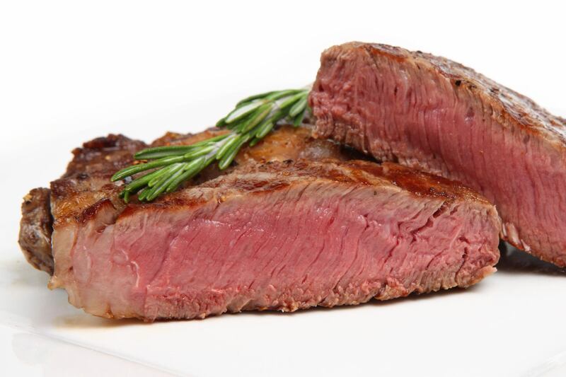Freshly griddled rib-eye steak on a white plate (iStockphoto.com)