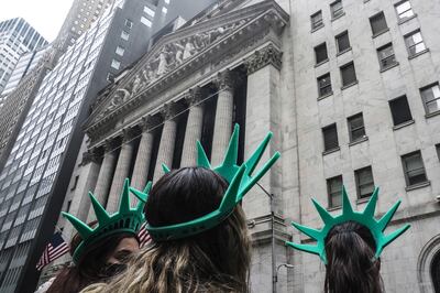 Visitors wearing Lady Liberty souvenir headwear outside the New York Stock Exchange. The S&P 500 index, Wall Street’s main barometer of health, rose less than 1 point on Friday, leaving it 18.7 per cent below its high set on January 3. AP