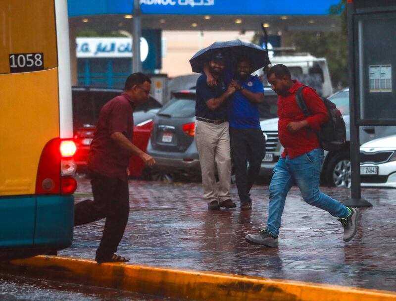 Abu Dhabi commuters get caught in the rain. Victor Besa / The National
