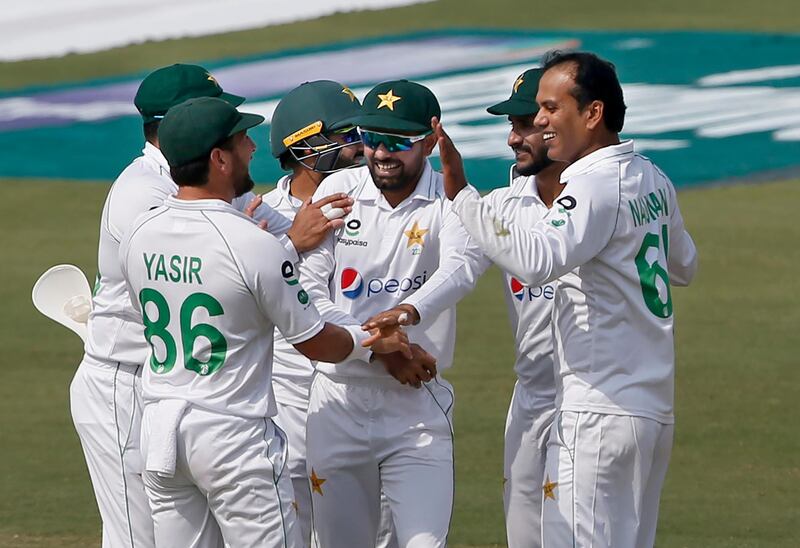 Pakistan's Nauman Ali, right, celebrates after taking the wicket of South Africa's Dean Elgar. AP