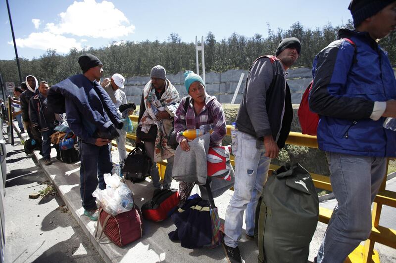 epa06965295 Venezuelan citizens who travel by bus to the Ecuadorian border with Peru pass through Quito, Ecuador, 22 August 2018. The Prefecture of the Ecuadorian province of Pichincha, whose capital is Quito, has created a 'citizen corridor' to move from the border with Colombia, by bus, Venezuelan migrants who try to reach Peru. There are six buses with 42 migrants, each traveling to the city of Huaquillas, on the border with Peru. A total of 252 Venezuelans are part of this caravan that is expected to arrive in Huaquillas in the next few hours, on a journey estimated to take about 20 hours.  EPA/Jose Jacome