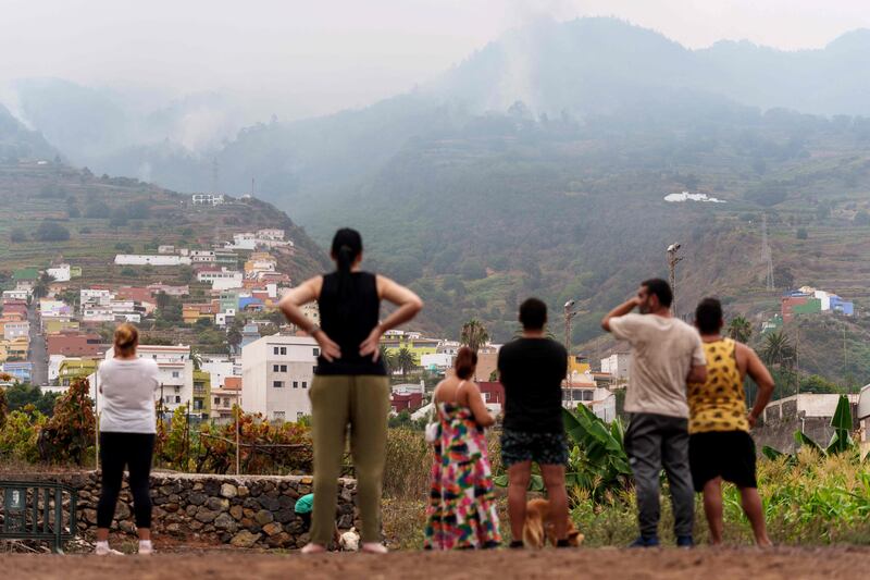 People from Santa Ursula watch a huge wildfire burning through forests surrounding the Mount Teide volcano. AFP