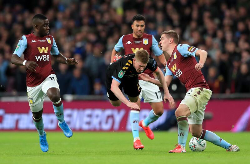 Manchester City's Kevin De Bruyne, centre, battles for the ball with Aston Villa's Bjorn Engels. PA
