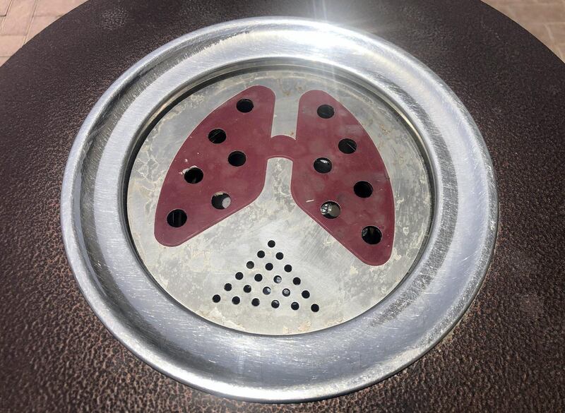 Dubai, United Arab Emirates - Reporter: N/A. Business. General view of a ash tray on the top of a bin. The ashtray has a pair of lungs printed on it. Tuesday, July 21st, 2020. Dubai. Chris Whiteoak / The National
