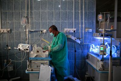 FILE - In this Saturday, June 27, 2020 file photo, a doctor checks a malnourished newborn baby inside an incubator at Al-Sabeen hospital in Sanaa, Yemen. Coronavirus restrictions on movement have blocked the distribution of aid, along with the stalling of salaries and price hikes. (AP Photo/Hani Mohammed)