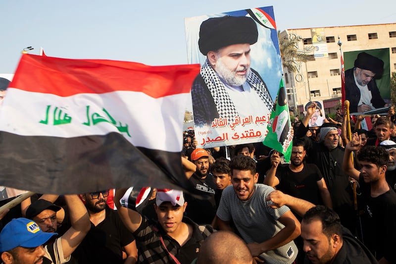 Mr Al Sadr's supporters chant pro-peace slogans during a protest in Basra, Iraq. AP