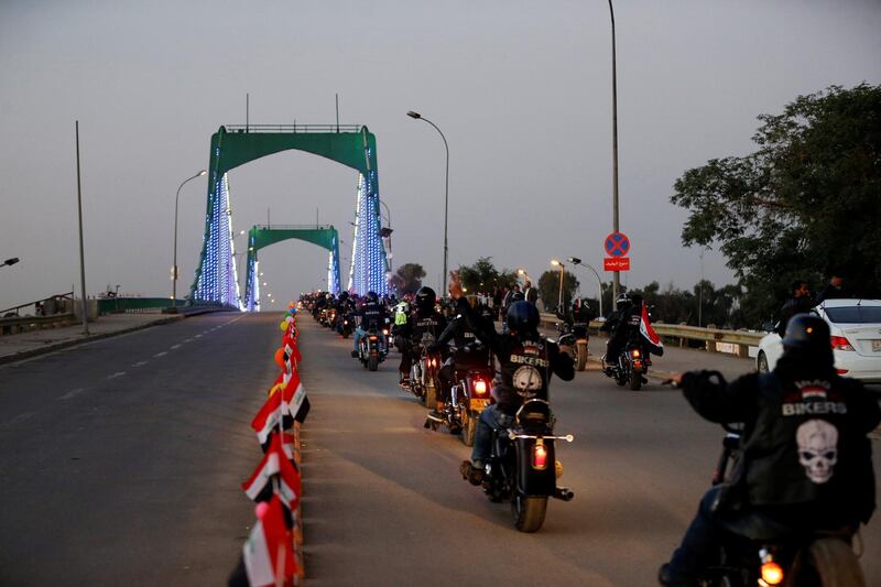 Motorcycles drive over a suspension bridge in the Green Zone in Baghdad. Reuters