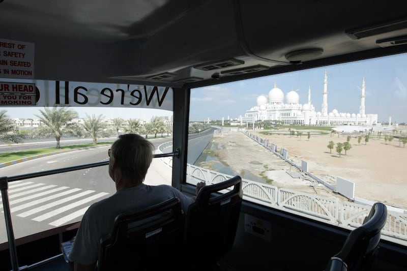 A passenger aboard a Big Bus Tours bus on the way to Sheikh Zayed Mosque in Abu Dhabi. Jaime Puebla / The National