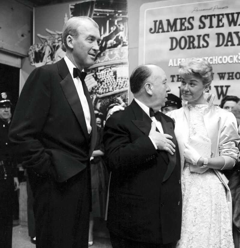 LOS ANGELES -  MAY 22, 1956: Director Alfred Hitchcock with actor Jimmy Stewart and actress Doris Day at the premier of "The Man Who Knew Too Much" in Los Angeles, California. (Photo by Earl Leaf/Michael Ochs Archives/Getty Images)
