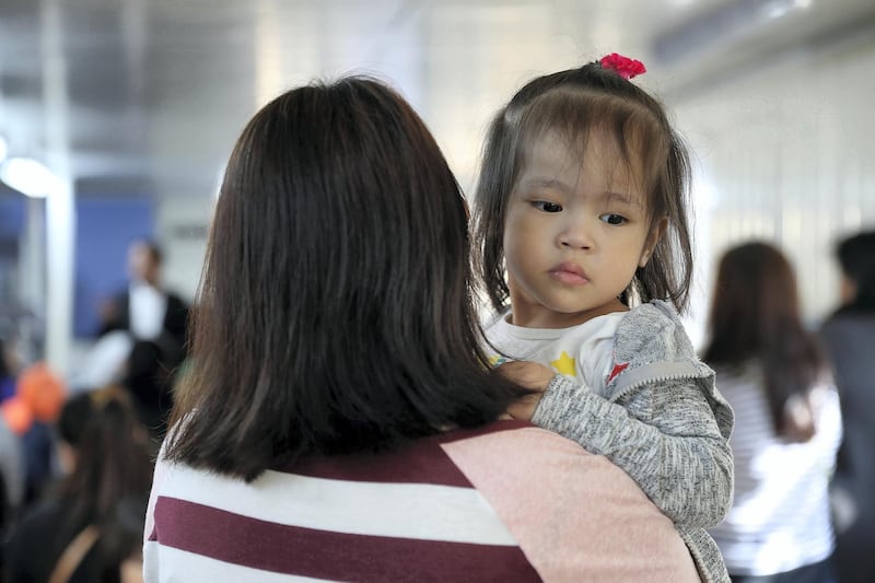 DUBAI , UNITED ARAB EMIRATES , FEB 02 – 2018 :- One of the jobless mother with her daughter listening  the guidance of Arthur Blais, Social worker at the Philippine consulate in Al Qusais 3 in Dubai. (Pawan Singh / The National) For News. Story by Ramola 