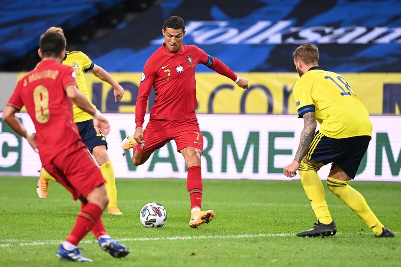 Portugal's forward Cristiano Ronaldo shoots to score his second goal during the UEFA Nations League football match between Sweden and Portugal on September 8, 2020 in Solna, Sweden. (Photo by Jonathan NACKSTRAND / AFP)