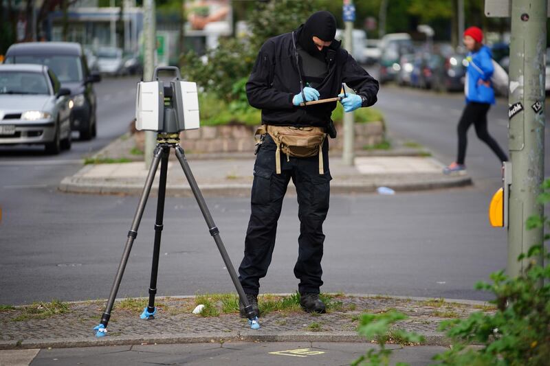 A police officer takes measurements in front of the Al-Irschad association building. EPA