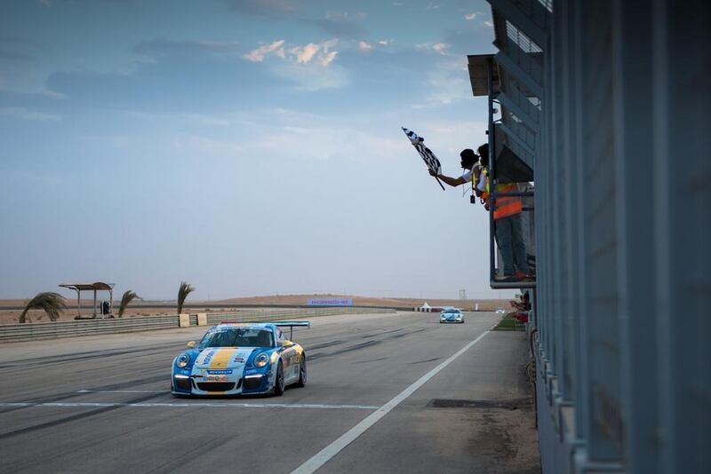 Jeffrey Schmidt, of Al Nabooda Racing takes the checkered flag during the Porsche GT3 Cup Challenge Middle East, Round 2 at Saudi Arabia’s Al Reem Circuit. Courtesy HK Strategies