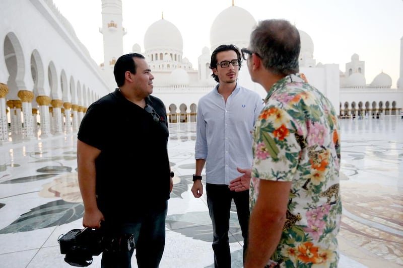 The filmmaker Ali F Mostafa, centre, says his short film that accompanies Ishy Bilady includes several familiar scenes and landmarks as well as "cool re-enactments". Fatima Al Marzooqi/ The National

