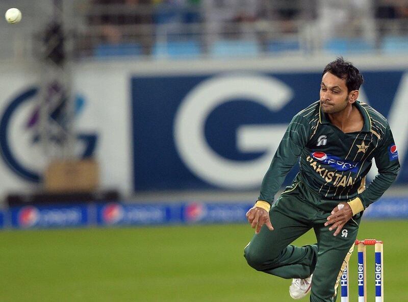 Mohammad Hafeez shown delivering a ball during the second T20 against New Zealand on Friday in Dubai. Aamir Qureshi / AFP / December 5, 2014