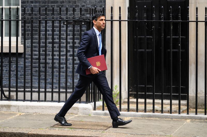 LONDON, ENGLAND - MAY 26: Chancellor Rishi Sunak leaves number 11, Downing Street on May 26, 2022 in London, England. An announcement is expected to be made by Chancellor Rishi Sunak later, knocking hundreds of pounds off domestic energy bills this winter, largely funded by a windfall tax on oil and gas firms that could raise £7bn. (Photo by Leon Neal / Getty Images)