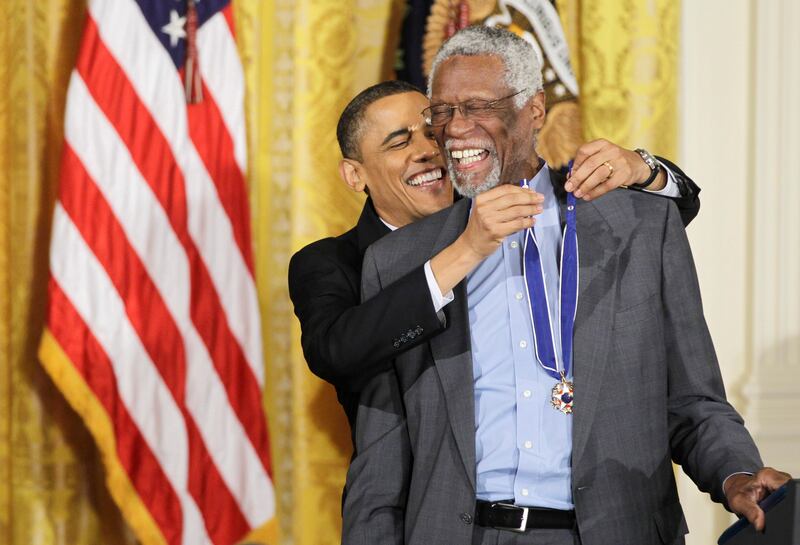 Mr Obama presents the Presidential Medal of Freedom to basketball Hall of Fame member Bill Russell in 2011. AP