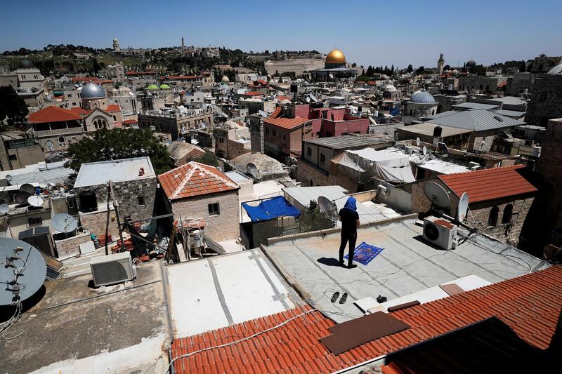 A Muslim worshipper prays on Friday Ramadan on a roof inside Jerusalem's Old City due to the coronavirus disease (COVID-19) restrictions around the country May 1, 2020. REUTERS/Ammar Awad     TPX IMAGES OF THE DAY
