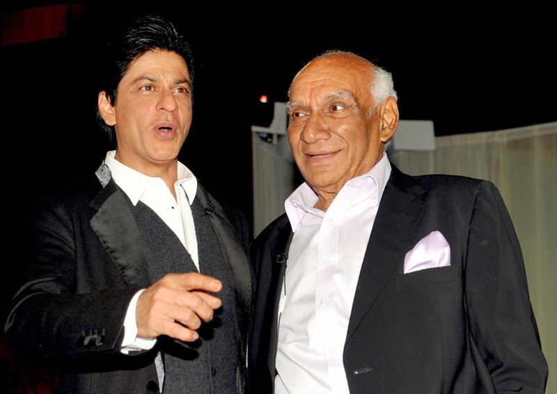 Indian Veteran Bollywood filmmaker, director, screenwriter and producer Yash Raj Chopra (R) celebrates his 81st birthday with actor Shah Rukh Khan (L) at a film promotion in Mumbai on September 27, 2012. AFP PHOTO/ STR