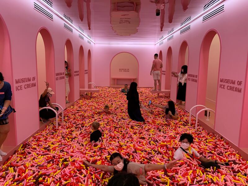 Visitors play in a 'sprinkle pool' at the Museum of Ice Cream in Singapore. Reuters