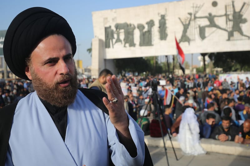 Ibrahim al-Jabiri, one of the leaders of Iraq's Shiite Sadr Movement, gives an interview during a demonstration by the movement in the capital Baghdad's Tahrir square against corruption in the Iraqi government on March 2, 2018.
Followers of a black-turbaned Shiite cleric are seeing red ahead of Iraq's May elections, allying with the once-powerful communist party for the first time in the country's history.
 / AFP PHOTO / AHMAD AL-RUBAYE
