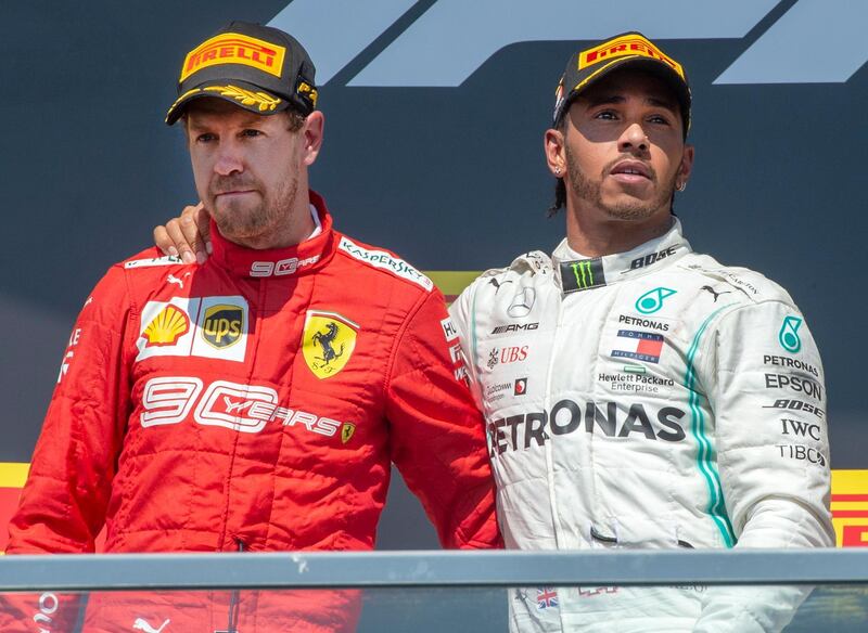 Mercedes driver Lewis Hamilton, right, of Britain, consoles Ferrari driver Sebastian Vettel, of Germany, after Hamilton won the Formula One Canadian Grand Prix auto race Sunday, June 9, 2019 in Montreal. Vettel finished first but was assessed a penalty to end up in second place. (Ryan Remiorz/The Canadian Press via AP)