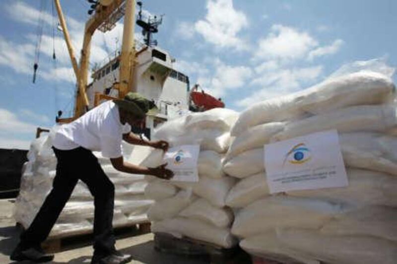 Workers load supplies on to a cargo ship at the Lavrio port, about 60 kilometres southeast of Athens, Greece, on Friday, July 9, 2010.