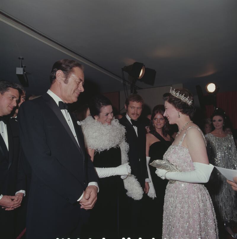 Queen Elizabeth meets actor Rex Harrison and his wife Rachel Roberts at the premiere of 'Dr Dolittle' in London. Getty