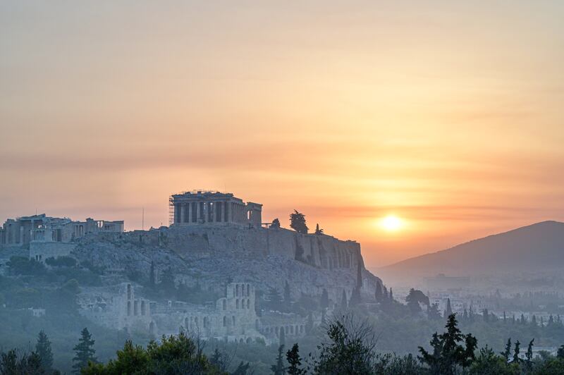 The Parthenon temple on Acropolis hill in Athens is seen through smoke caused by a wildfire north of the Greek capital.