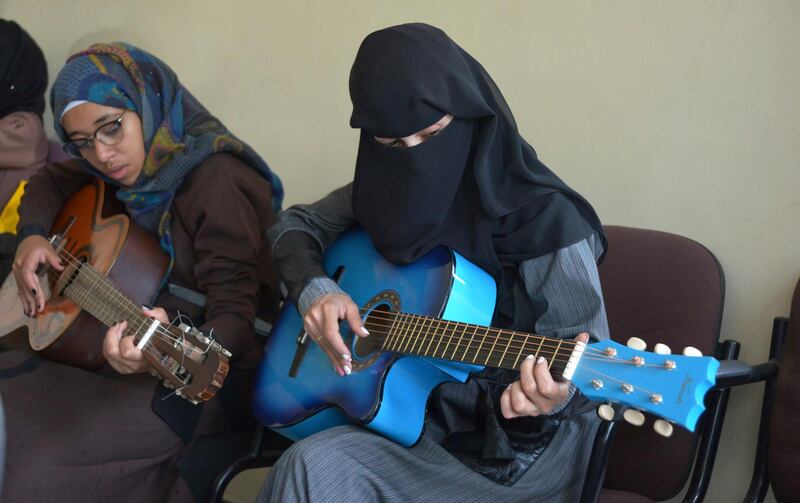Female Yemeni music students practice playing the guitar during a music class at the Cultural Centre in Sanaa, Yemen. Hani Mohammed / AP Photo