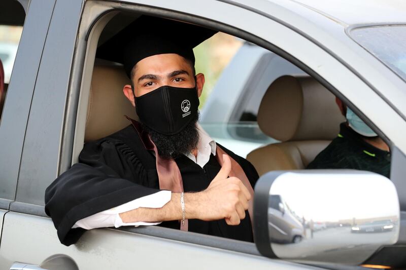 Ajman, United Arab Emirates - Reporter: Anam Rizvi. News. Khaled Hadi waits in his car before his drive through graduation from Ajman University because of Covid-19. Wednesday, February 10th, 2021. Ajman. Chris Whiteoak / The National