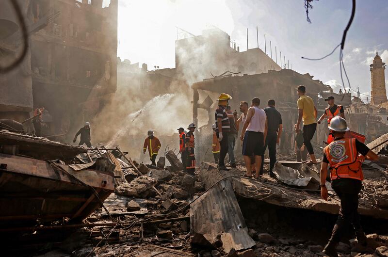 Rescuers and onlookers gather at the scene of the blast in Gaza City, the cause of which has not yet been determined. AFP