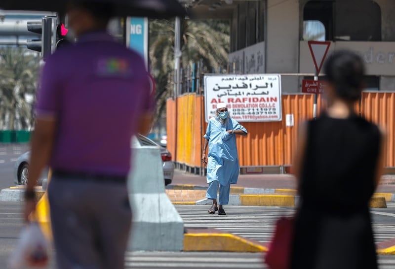 Abu Dhabi, United Arab Emirates, September 18, 2020.  Pedestrians cross the street at central Abu Dhabi on Friday afternoon.Victor Besa /The NationalSection:  NA/Standalone.