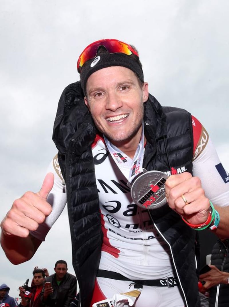 DUBAI, UNITED ARAB EMIRATES - JANUARY 29:  Jan Frodeno of Germany poses with his medal after winning the Men's IRONMAN 70.3 Dubai on January 29, 2016 in Dubai, United Arab Emirates.  (Photo by Warren Little/Getty Images for Ironman)