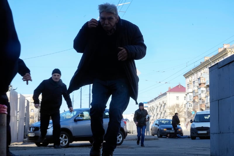 People run for cover during the shelling on the city of Kiev. AP