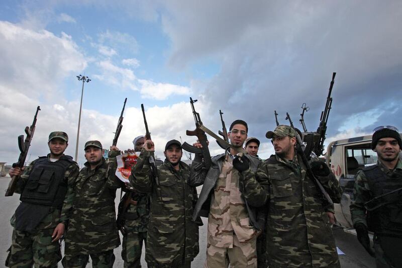 Libyan gunmen celebrate on the early morning of the second anniversary of the revolution that ousted Moammar Gadhafi, in Benghazi, Libya, Sunday, Feb, 17 2013.  (AP Photo/Mohammad Hannon)
