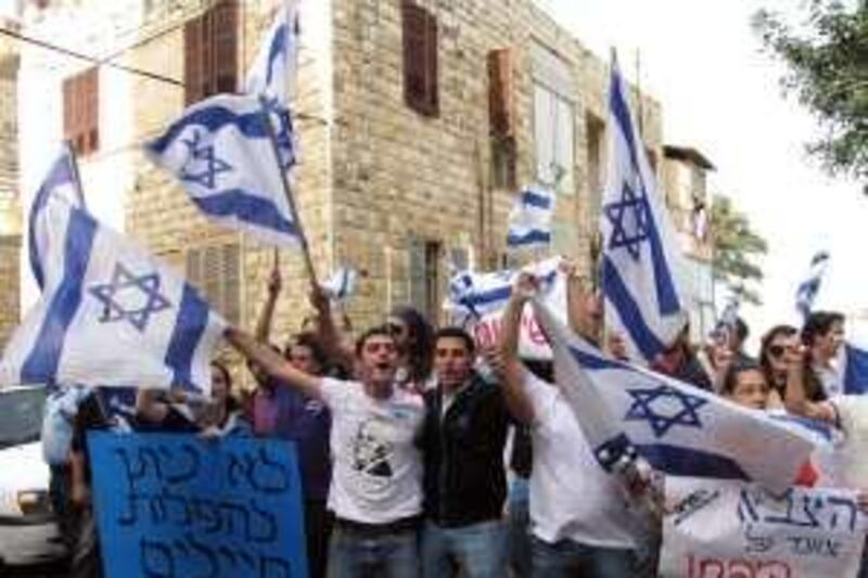 UNDATED HANDOUT IMAGE. HAIFA ISRAEL. Police hold back demonstrators as they protest outside Azad restaurant in Haifa over its decision to refuse to serve an Israeli soldier in uniform. The Hebrew banners translated:  The blue one says: "DonÕt discriminate against soldiersÓ The white one needs a non-literal translation but means the equivalent of: ÒSoldiers keep us safeÓ. UNDATED HANDOUT IMAGE. HAIFA ISRAEL. Police hold back demonstrators as they protest outside Azad restaurant in Haifa over its decision to refuse to serve an Israeli soldier in uniform. The Hebrew banners translated:  The blue one says: "DonÕt discriminate against soldiersÓ The white one needs a non-literal translation but means the equivalent of: ÒSoldiers keep us safeÓ. COURTESY Rizek Sahury / Haifanet
