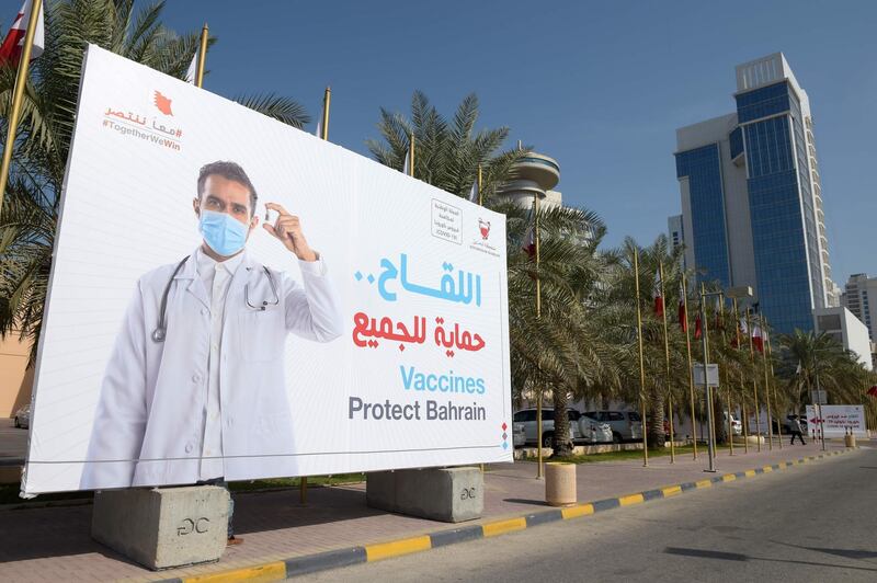 A large billboard carries a message encouraging people to take part in a voluntary free vaccination campaign against COVID-19 outside the Bahrain International Exhibition and Convention Center in the capital Manama, on December 24, 2020.    In Bahrain, which has recorded more than 90,000 cases including 350 deaths, vaccinations continued today. It has approved both the Pfizer-BioNTech vaccine and another developed by Chinese firm Sinopharm. / AFP / Mazen Mahdi
